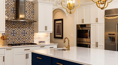 Elegant kitchen with white cabinetry and gold fixtures